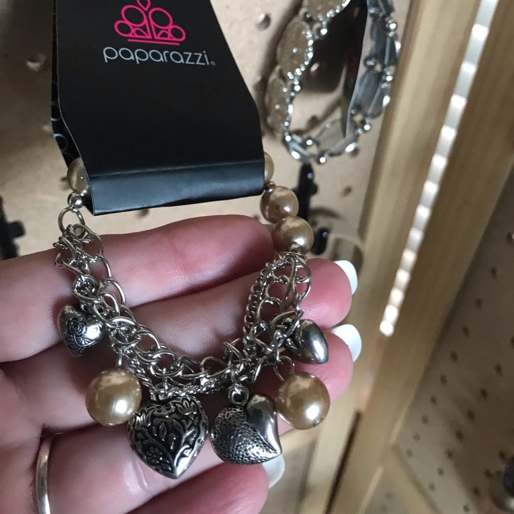 Silver chain w/feathers and tan pearl charms.